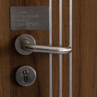 oznaczenie drzwi pracowni szkolnej alfabetem Braille'a